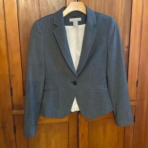 Darkest grey blazer with slight pattern to fabric.